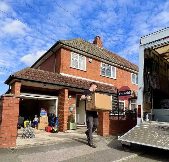 Removal team member carrying boxes on moving day in Huddersfield, house removals across Kirklees